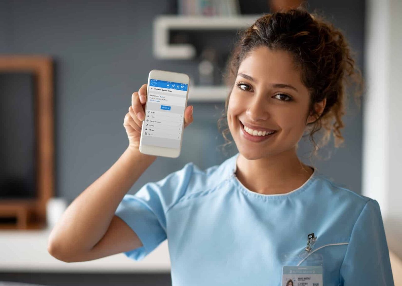 Girl holding up a phone showing the clock in on the mobile app