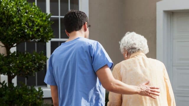 Home caregiver assisting senior citizen client