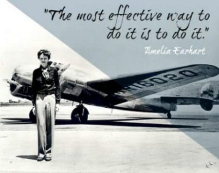 Amelia Earhart standing by plane