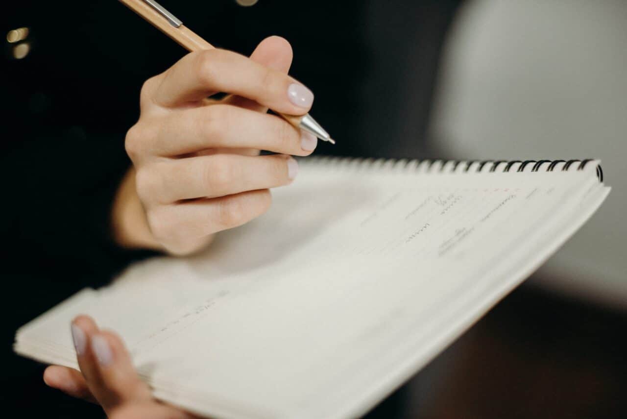 person writing in a notebook