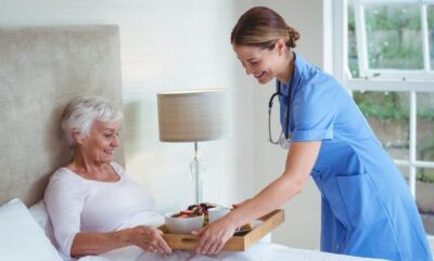 caregiver bringing food to patient