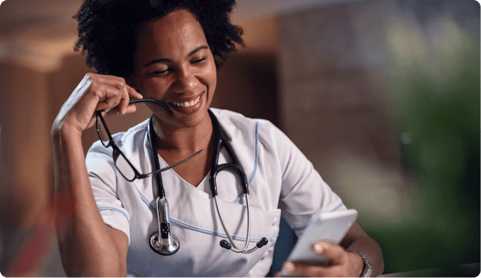 caregiver smiling looking at phone