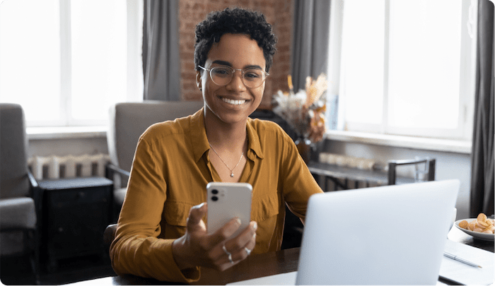 woman smiling holding phone