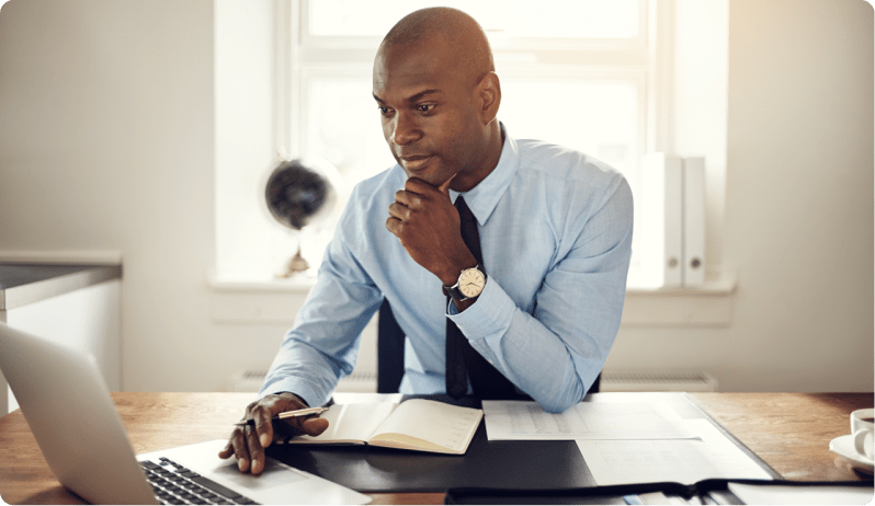 man at desk working on computer