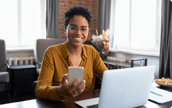 smiling woman holding phone