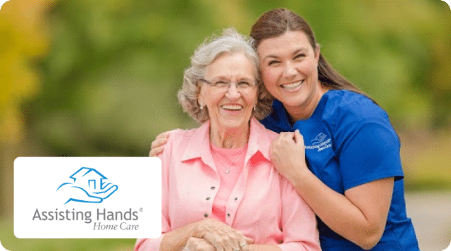 Older woman and caregiver smiling