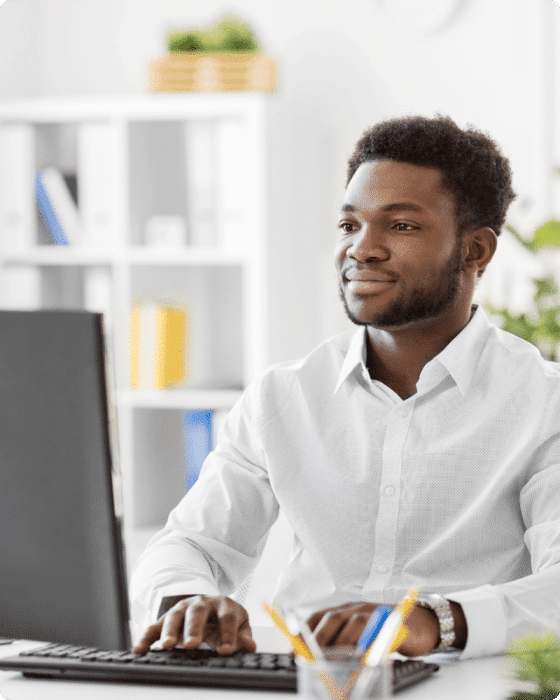 smiling man working on computer
