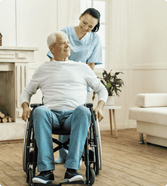 caregiver pushing elderly man in wheelchair