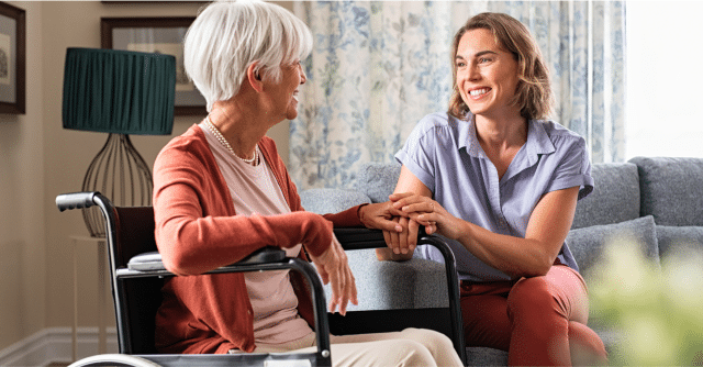 caregiver and elderly woman smiling