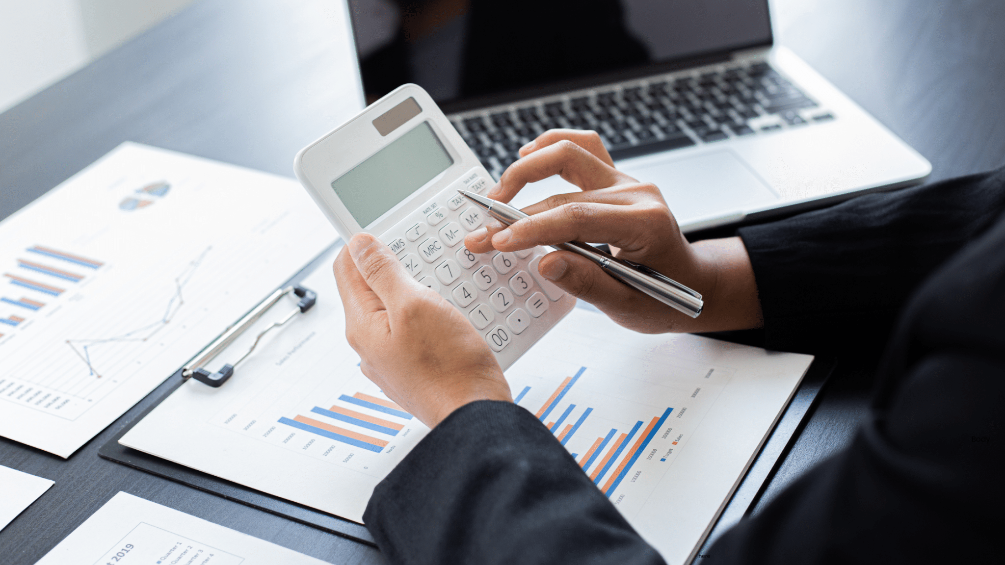 business person using calculator on desk