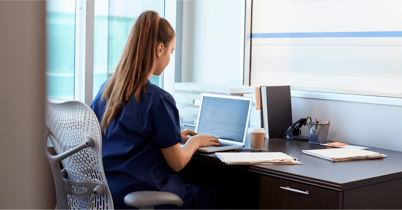 woman typing caregiver notes on computer