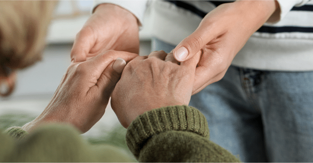 caregiver holding hands of client