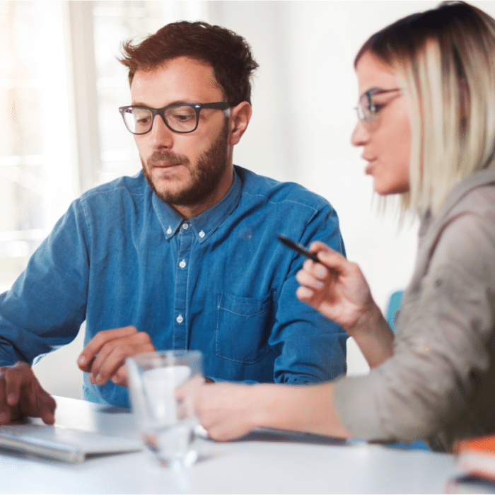 Man and woman working on computer togther