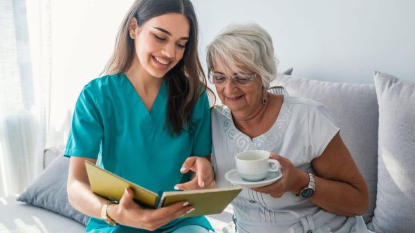 Caregiver reading to senior client