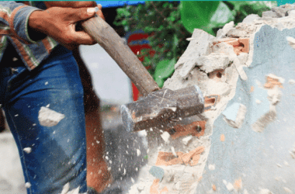 sledgehammer breaking a wall